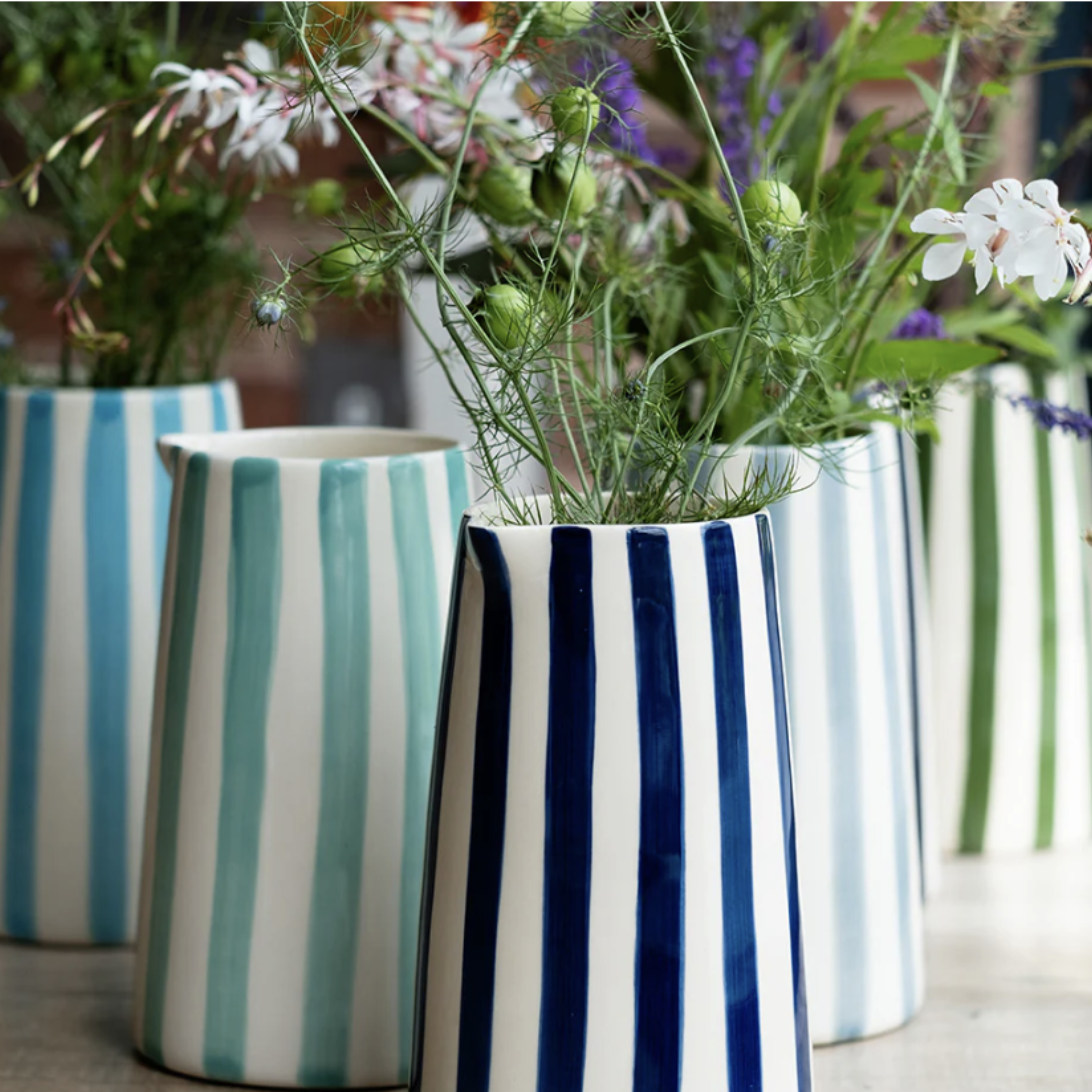 Hand-painted blue ceramic pitcher with candy stripe design, artisan Portuguese jug