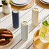 Navy blue Saucie bottle on dining table filled with sauce – reusable and modern kitchenware
