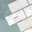 Several gift vouchers with the brand name 'saucie' laid out on a textured grey surface.