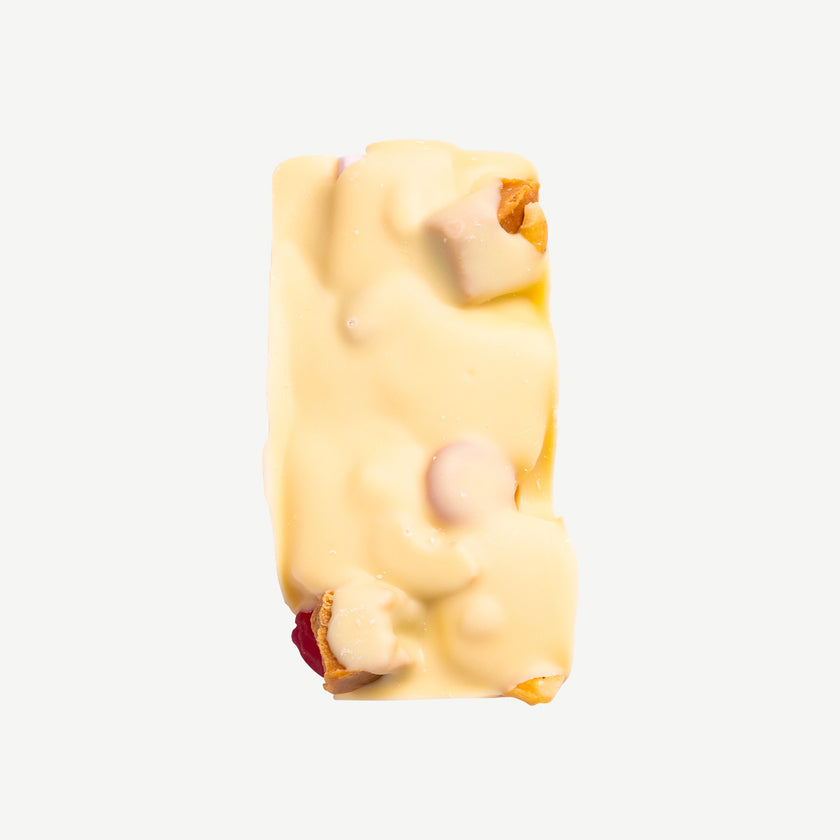 White chocolate rocky road with caramel fudge, marshmallows and raspberry lollies served on a plate – indulgent handmade treat