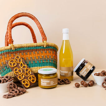 Picnic hamper with chutney, jam, honeycomb, raspberries, pretzel block & lemon basil cordial