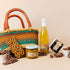 Picnic hamper with chutney, jam, honeycomb, raspberries, pretzel block & lemon basil cordial
