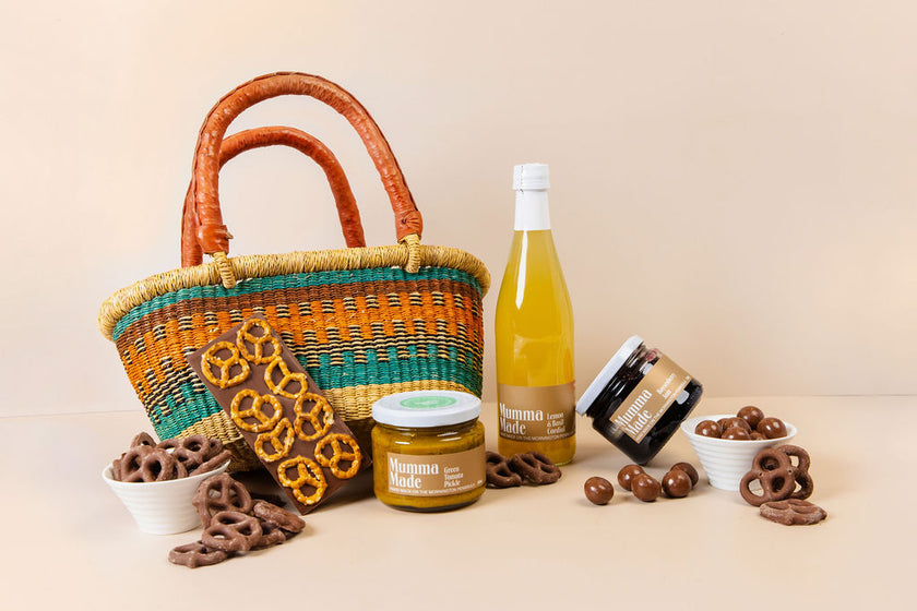Picnic hamper with chutney, jam, honeycomb, raspberries, pretzel block & lemon basil cordial