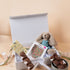 New parents opening Saucie New Baby Hamper with plush toy and handmade chocolates – thoughtful baby gift