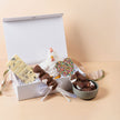 New Baby Hamper displayed at baby shower – premium Saucie gift with chocolates and cuddly toy