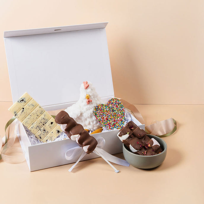 New Baby Hamper displayed at baby shower – premium Saucie gift with chocolates and cuddly toy