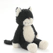 Black and white plush cat toy on a white background
