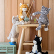 Plush toys on a wooden stool against a wooden paneled wall