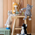 Plush toys on a wooden stool against a wooden paneled wall