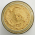 Jar of creamy spreadable food on a white background