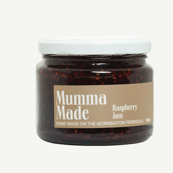 Jar of raspberry jam with 'Mumma Made' label on a white background