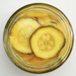 Jar of pickled cucumbers on a white background