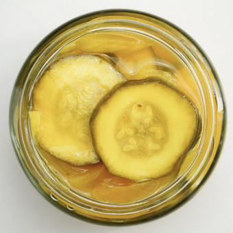Jar of pickled cucumbers on a white background