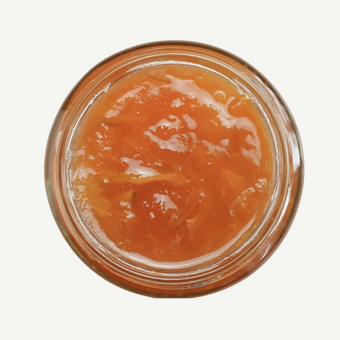 Jar of apricot jam on a white background