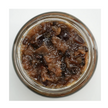 Jar of brown preserve on a white background