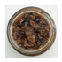 Jar of brown preserve on a white background