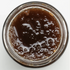 Close-up of a jar with a pear paste on a white background