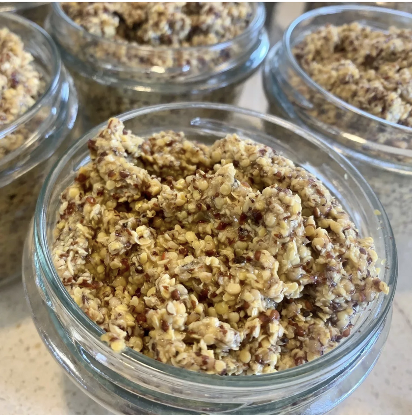 Glass jars filled with a crumbly, brownish mixture on a light surface.