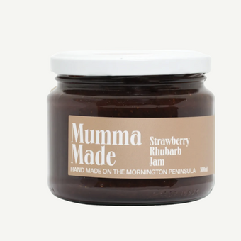 Jar of strawberry rhubarb jam with 'Mumma Made' label on a white background
